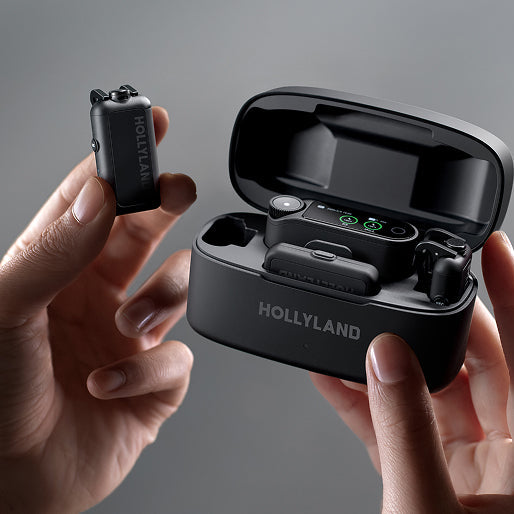 Hollyland wireless microphone system with receiver and transmitter in hands against a gray background